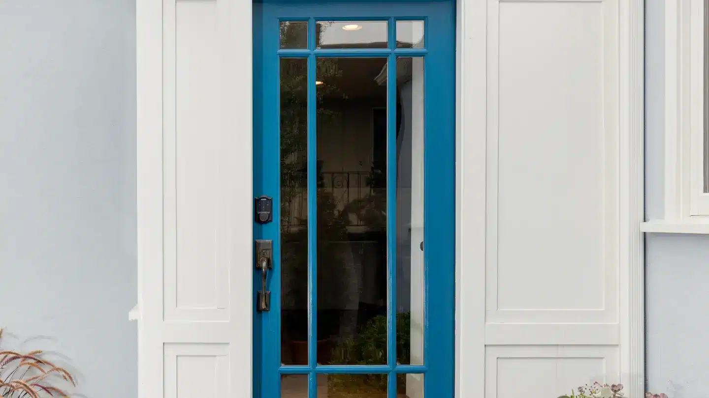 Blue fiberglass door with iron finishes and white trim. Blue fiberglass door with iron finishes and white trim.