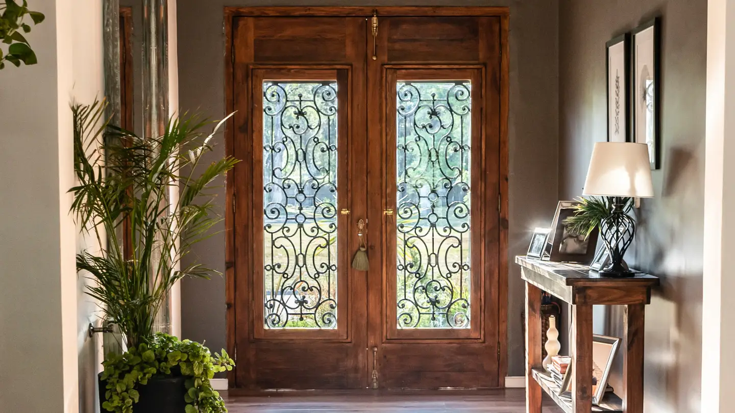 Brown wood door with iron on windows Brown wood door with iron on windows