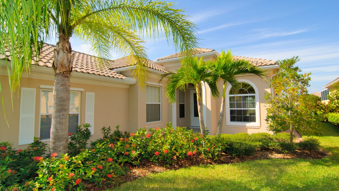 Beautiful Windows And Doors Ortega Fl Jacksonville Doors & Windows A beige home with white tree windows and bushes in front