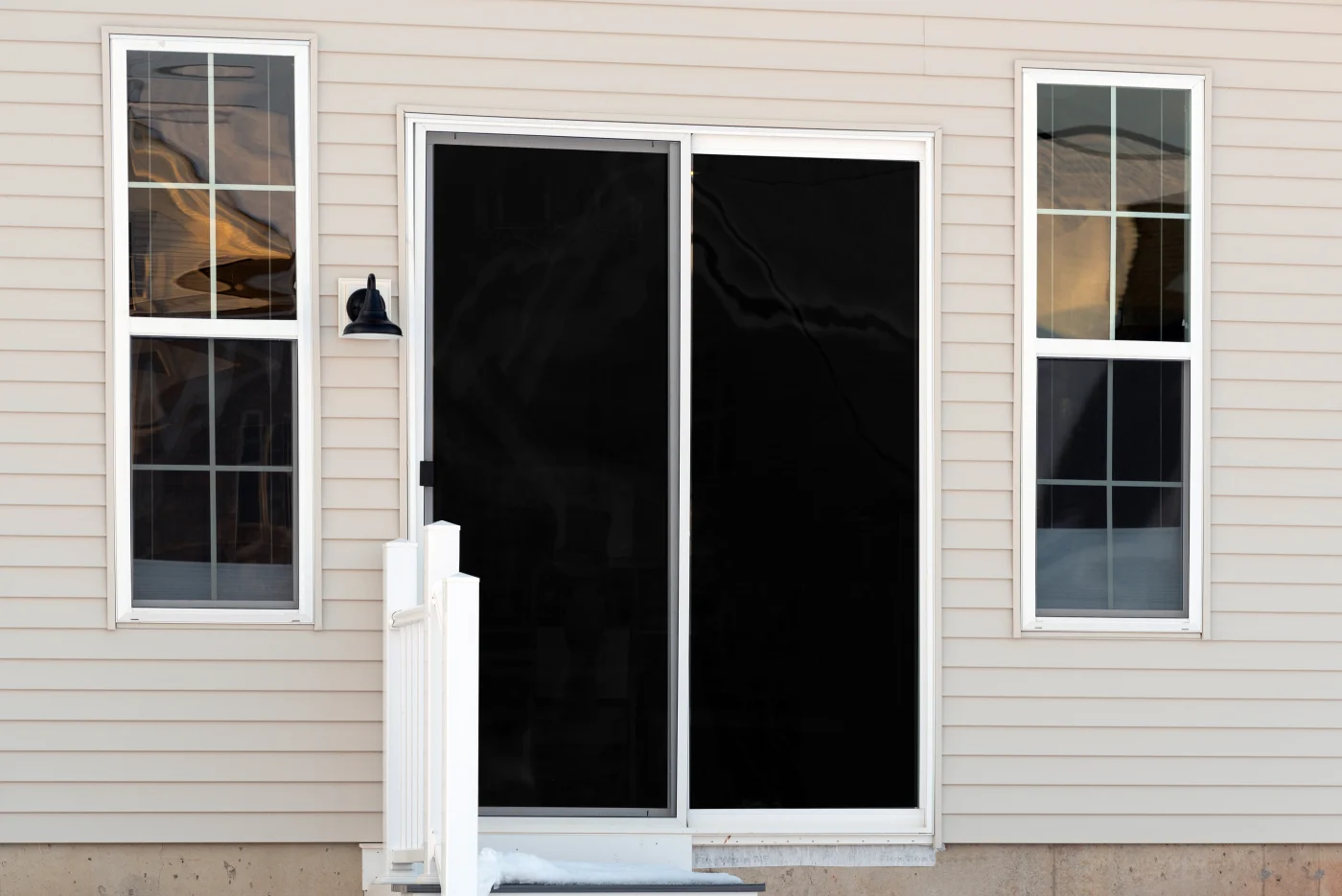 Sliding glass door with windows on either side from exterior
