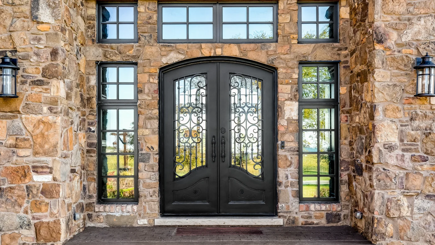 Dark brown door with a decorative design made of iron