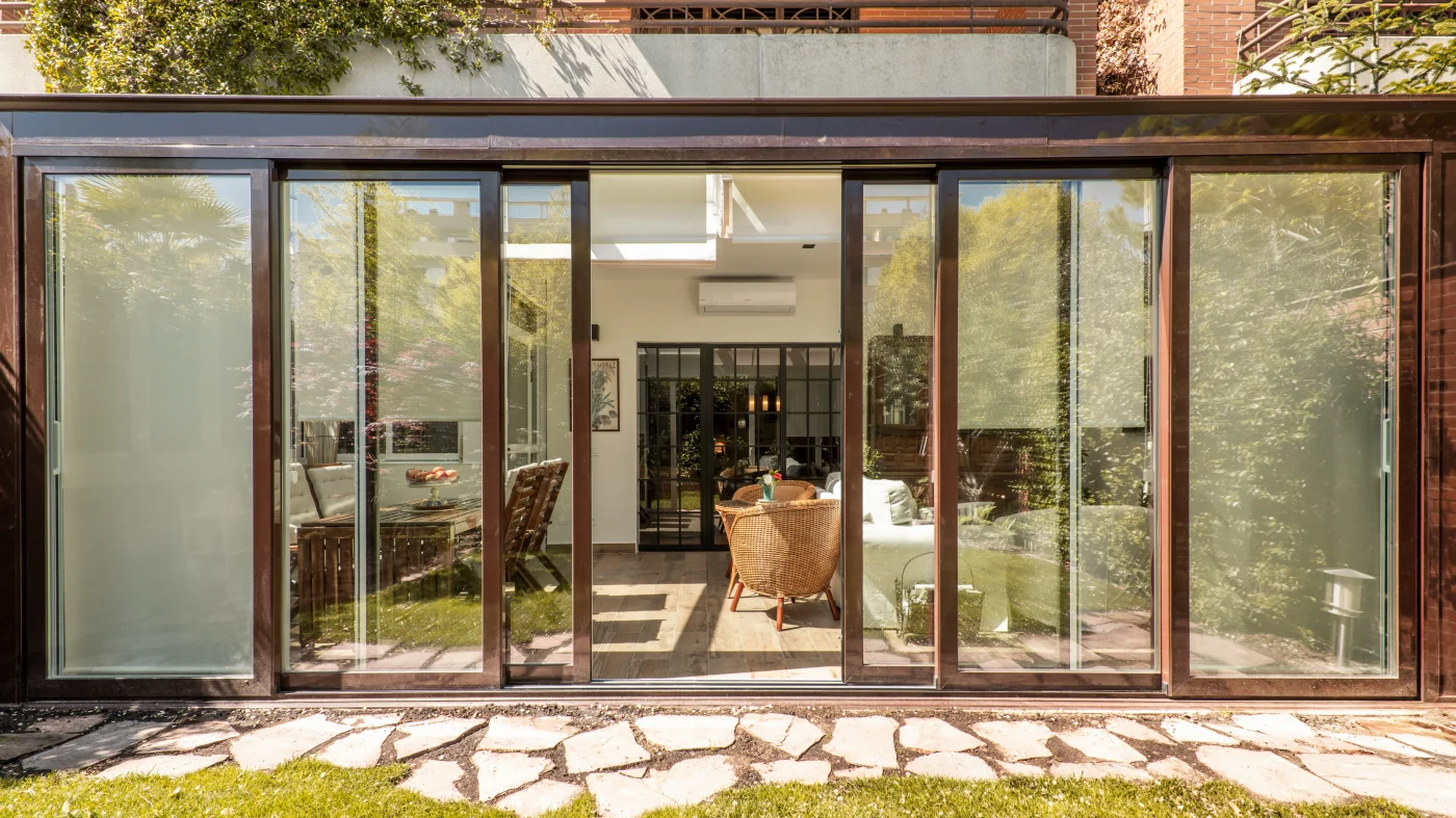 Patio door with brown aluminum structure and clear glass