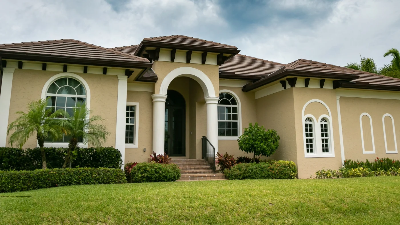 A beige home with white trim windows