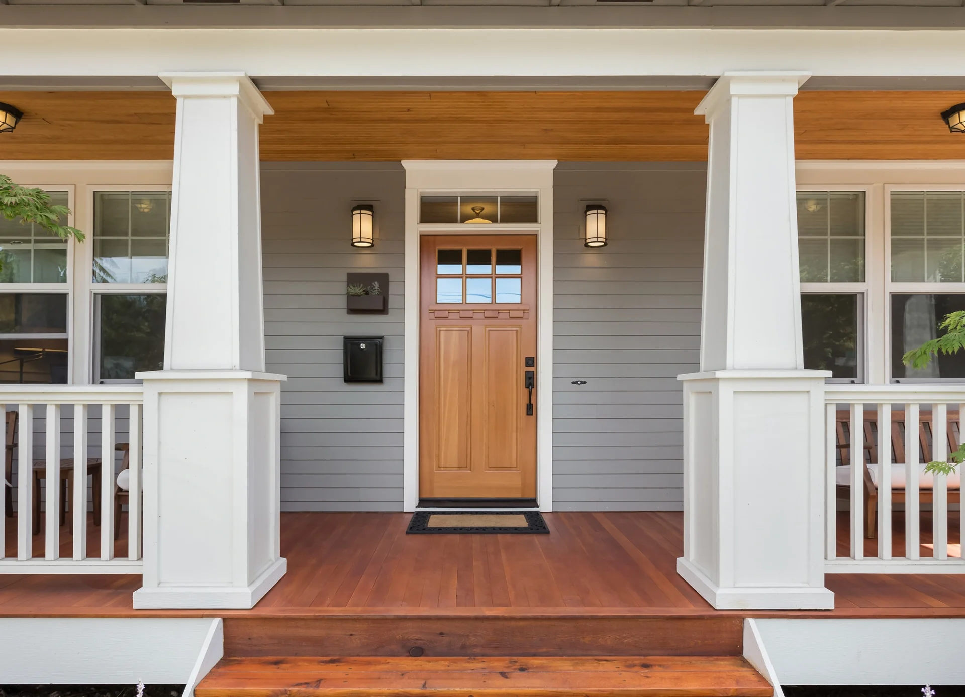 There is a brown wooden door against a gray wall