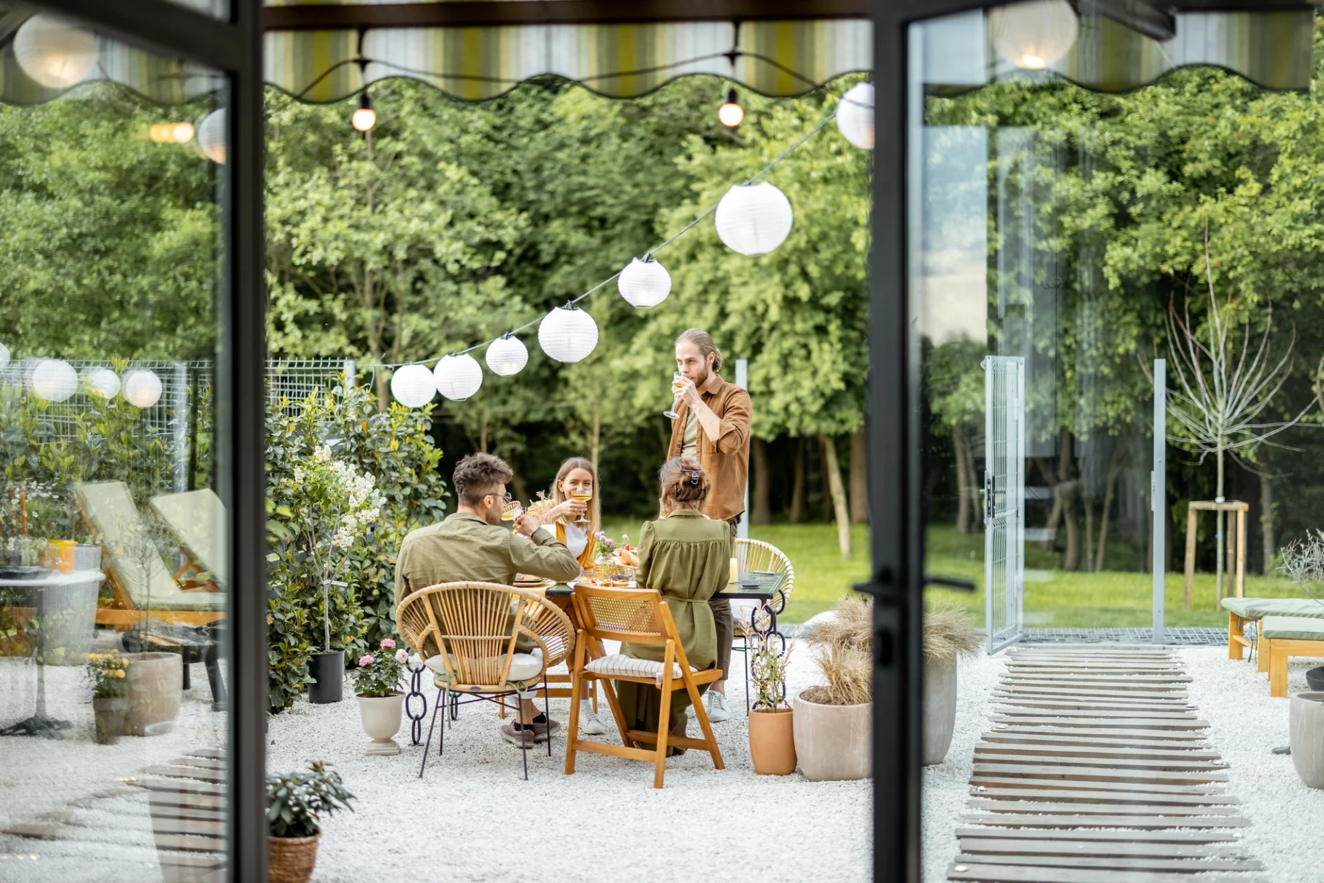 A small group of friends has a party after the host has gotten their patio door replaced