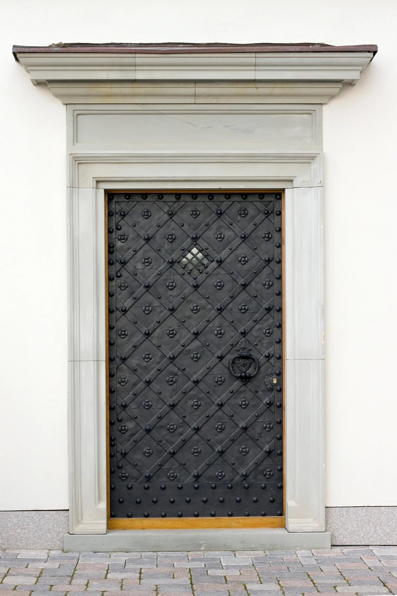A modern iron entry door features an eye-catching texture and sturdy construction