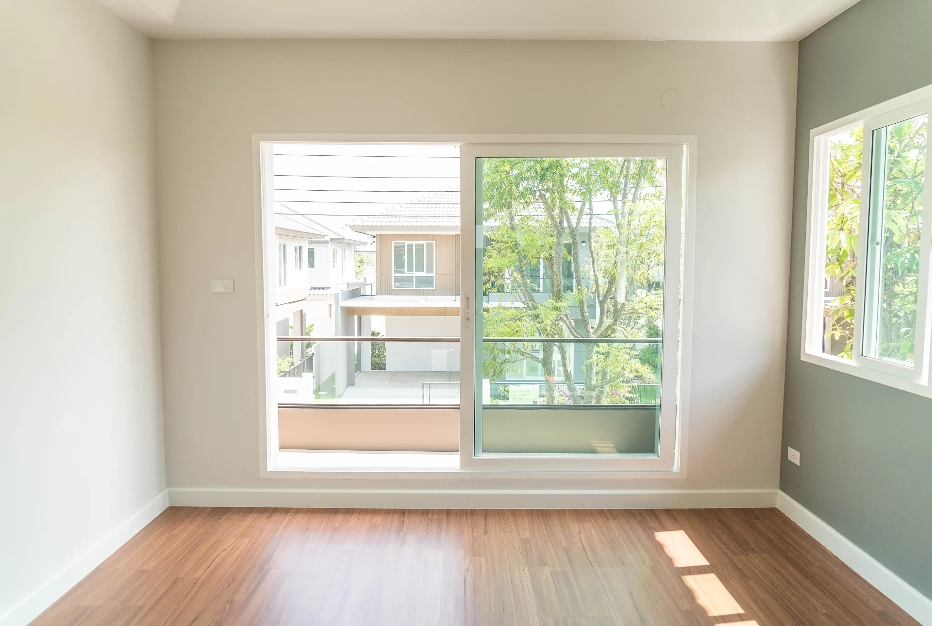 A sliding window affords an unobstructed view of the greenery outside.