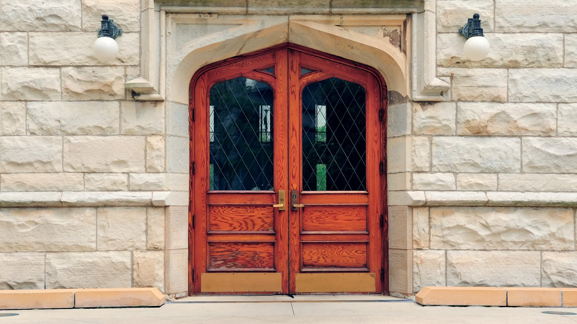 Home with stone exterior and rustic wood door with large glass inserts