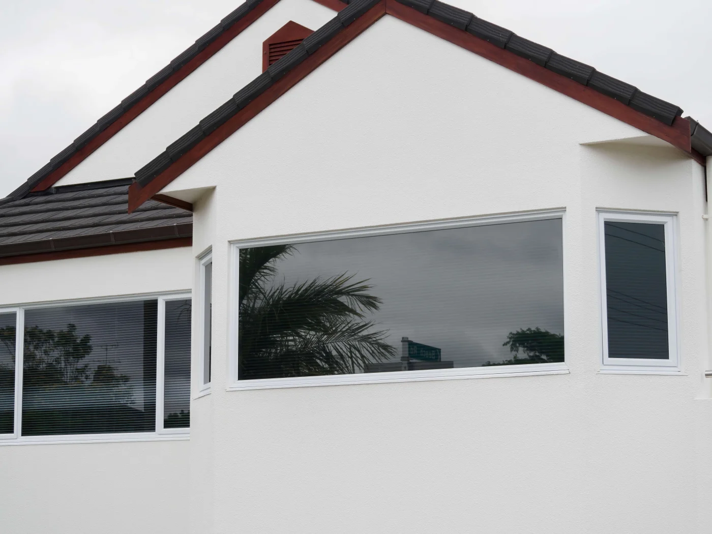A full home shot shows brand new windows with great curb appeal.
