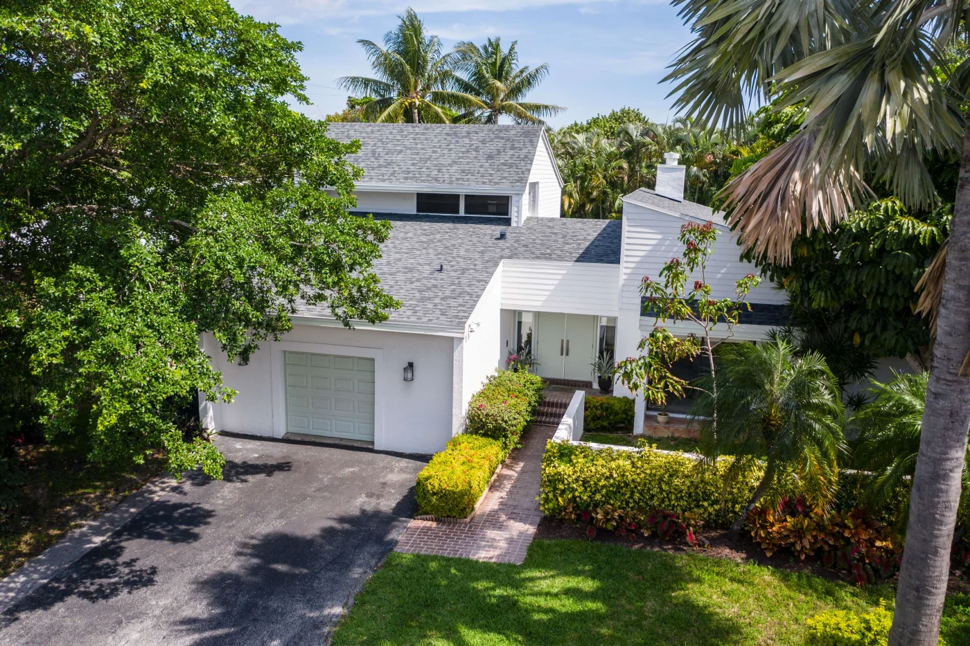 Dependable Windows And Doors In San Jose Forrest, FL | Jacksonville Doors & Windows White home with double entry doors in Florida neighborhood