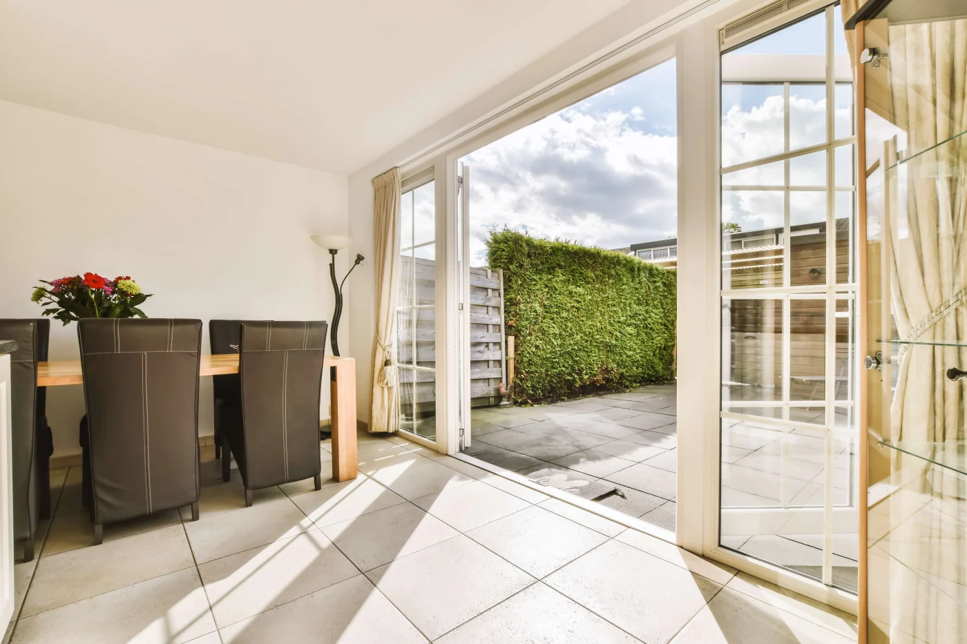White French patio doors with glass panels leading out to a patio
