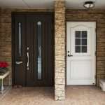Two townhome entrances - one with a dark wood door, and the other with a classic white door.