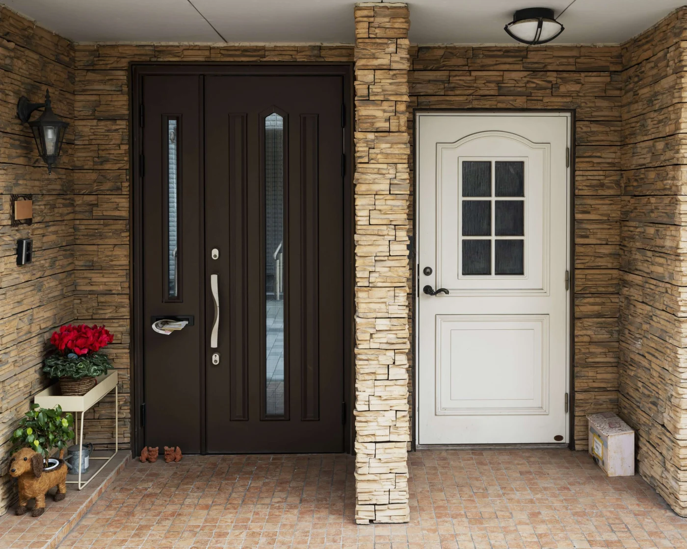 Two townhome entrances - one with a dark wood door, and the other with a classic white door.