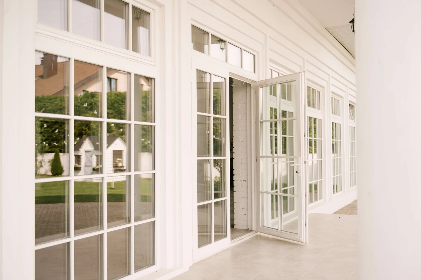 White and glass patio doors and windows with colonial grids.