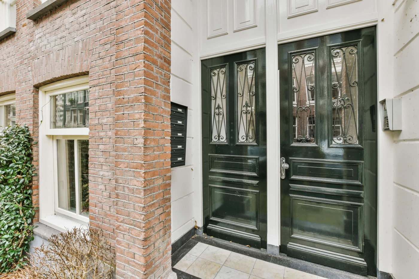 The Facade Of A Brick Building With Wooden Door The Facade Of A Brick Building With Wooden Door