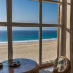 A beautiful view of the beach through hurricane-impact window replacements