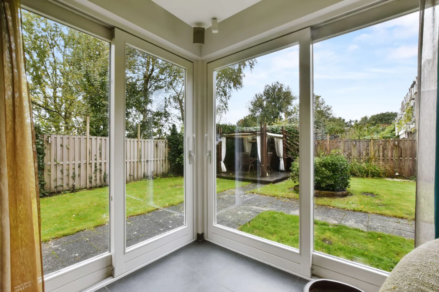 Excellent Replacement Doors in Vilano Beach, FL | Jacksonville Doors & Windows Newly installed patio doors with white frames overlooking a green backyard.
