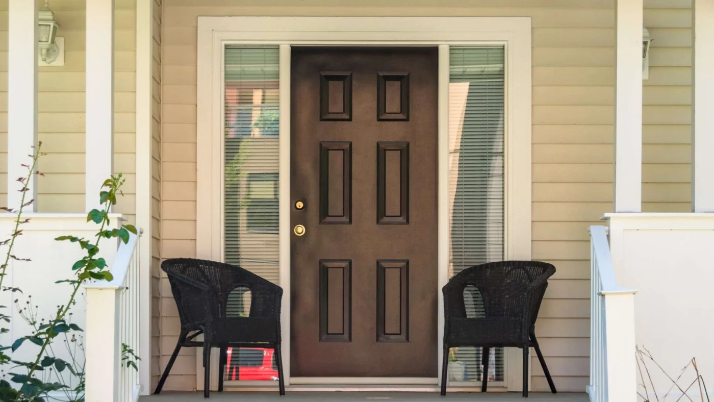 A wood door installed on a yellow house near Ortega Beach, FL.