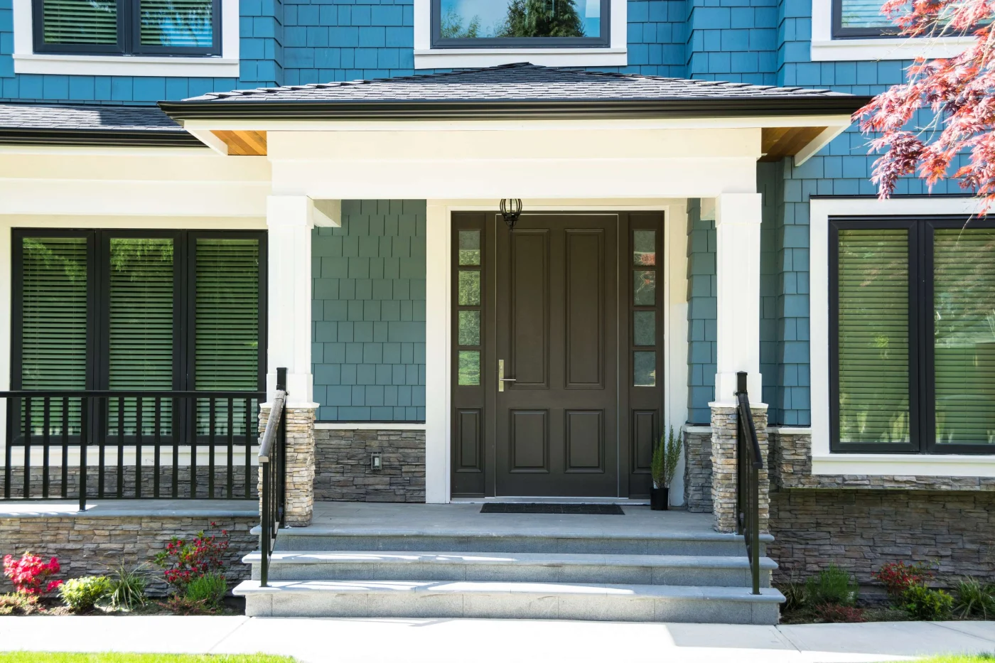 Front Entry Door Upgrades In Vilano Beach FL | Jacksonville Doors & Windows A dark brown wood entry door with sidelights on a Vilano Beach FL home.