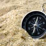 A compass in the sand, pointing north | Jacksonville Doors & Windows