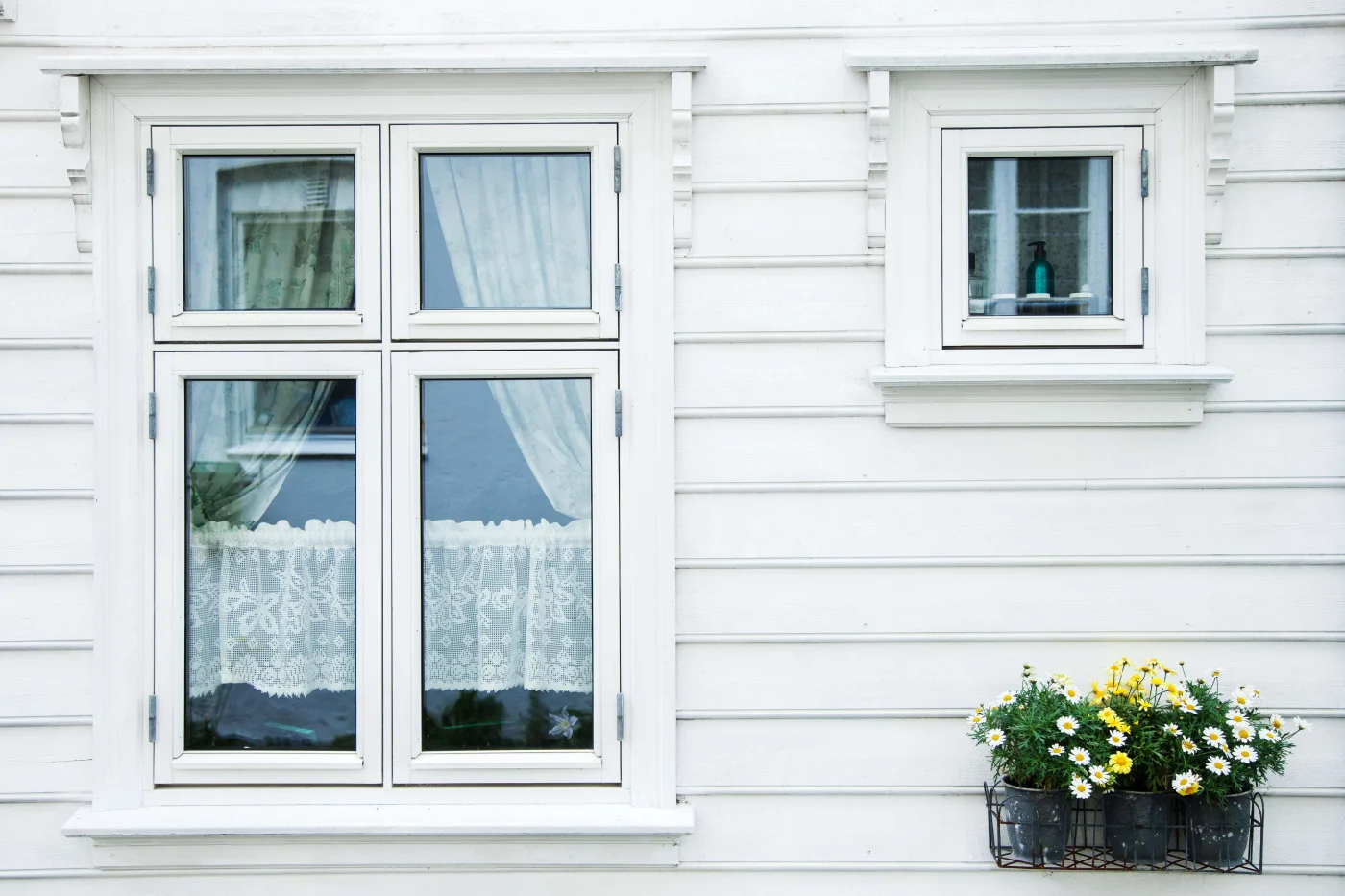 Lovely Window Replacement in Orange Park, FL | Jacksonville Doors & Windows New windows installed in the side of a house with white siding.