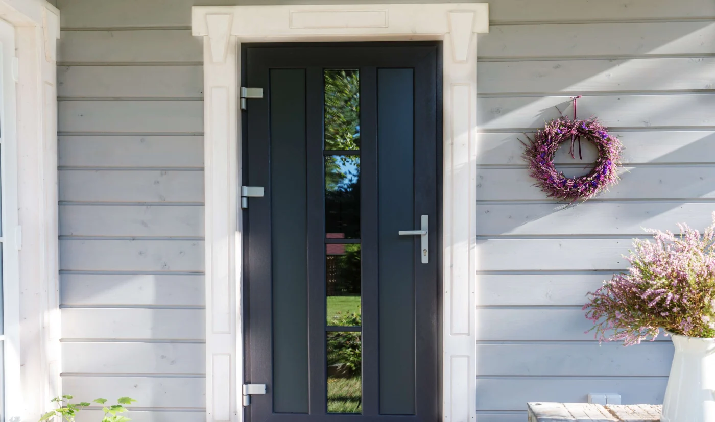 Quality Door Replacements in Orange Park, FL | Jacksonville Doors & Windows A black entry door with a glass insert on a house in Orange Park, FL.