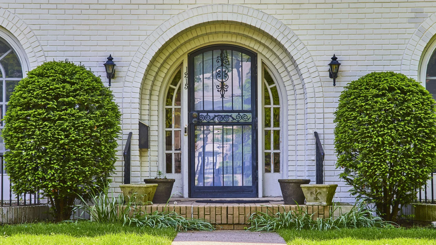 A custom iron front entry door on a white brick home in the Jacksonville Area.