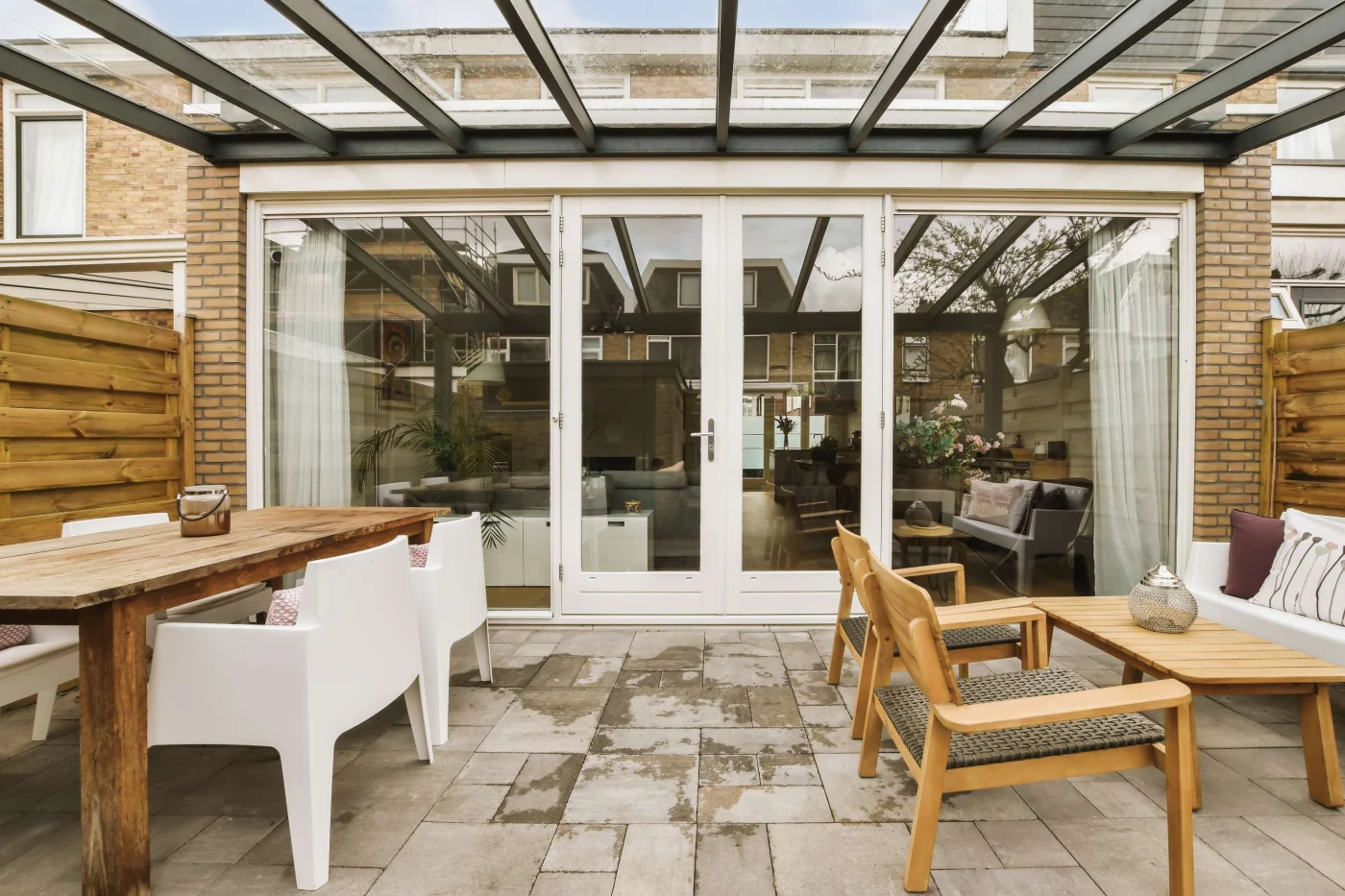 A covered patio area with new glass patio doors.
