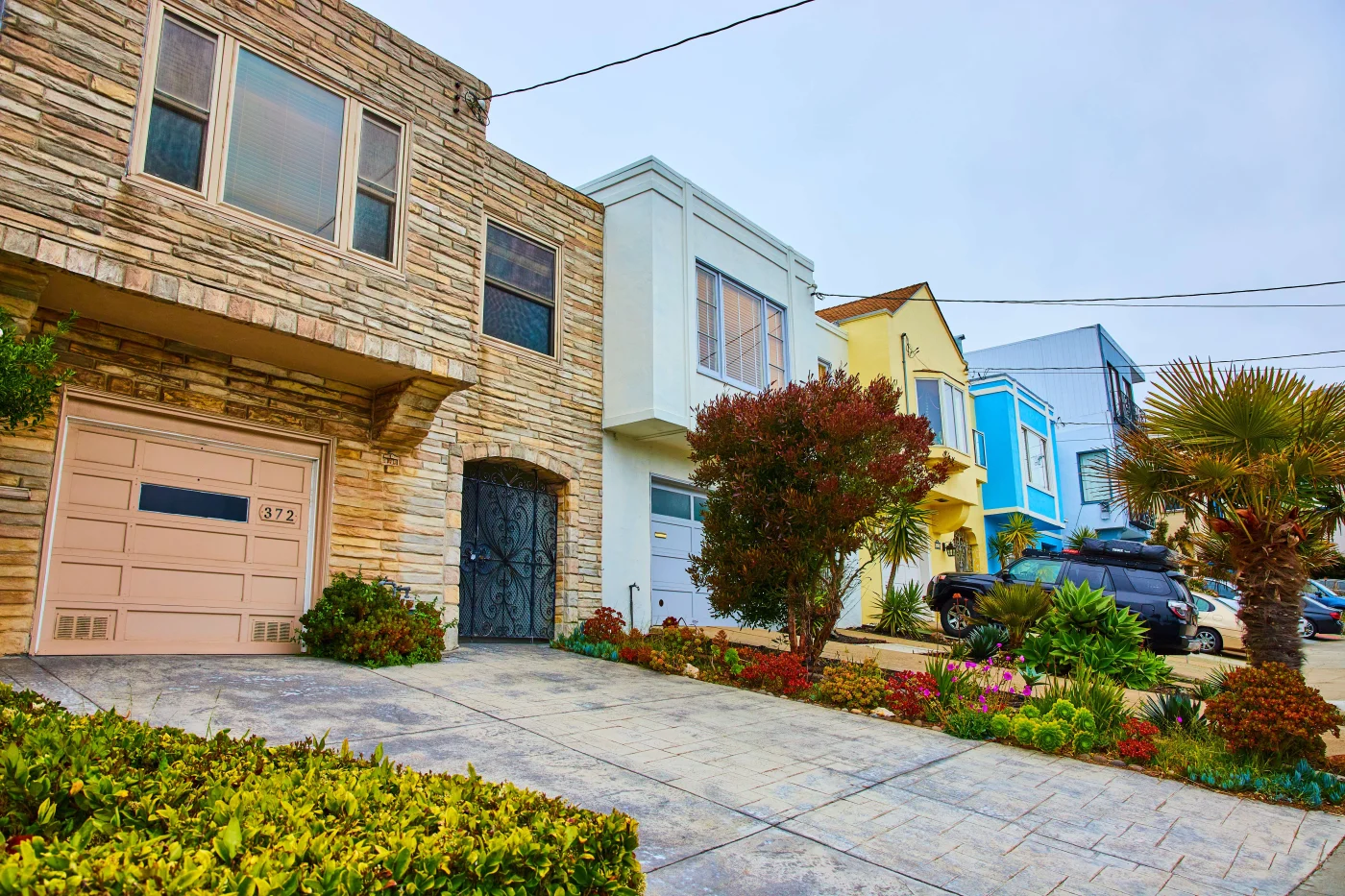 A row of houses with large new windows professionally installed by Jacksonville Doors & Windows.
